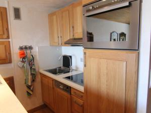 eine kleine Küche mit einer Spüle und einer Mikrowelle in der Unterkunft Appartement Huez, 1 pièce, 5 personnes - FR-1-405-200 in Huez