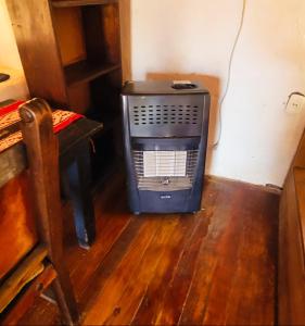 a small heater in a corner of a room at Wolf Totem Steam Punk Loft Villa in Pisac
