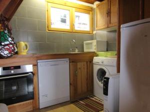 a kitchen with a washing machine and a washer at Chalet Huez, 3 pièces, 6 personnes - FR-1-405-184 in LʼHuez