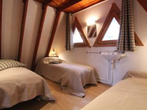 a bedroom with two beds and a sink and windows at Chalet Huez, 3 pièces, 6 personnes - FR-1-405-184 in LʼHuez