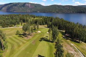 uma vista aérea de um campo de golfe ao lado de um lago em Hus i Telemarkskanalens hjerte em Ulefoss