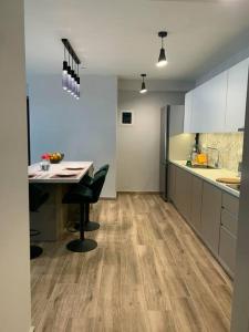 a kitchen with a desk and a table in a room at Just like Home in Sitia +1 photo