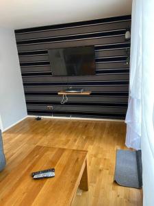 a living room with a television and a remote control on the floor at Garland way 2 bed house Sheffield free parking 5 min from m1 in Mosborough