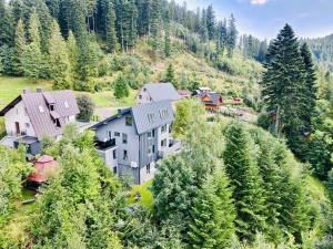 an aerial view of a house on a hill with trees at Apartament Widoknastok in Korbielów