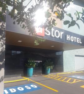 a sign for a stop hotel in a parking lot at Astor Hotel in Bauru