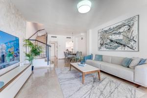 a living room with a couch and a table at Elegance Luxury Vacation House in Puerto de Santiago