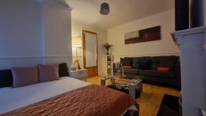 una camera d'albergo con un letto e un divano di B&R Place a Dublino