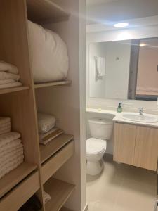 La salle de bains est pourvue d'un lavabo, de toilettes et d'un miroir. dans l'établissement Hermoso Apto con Vista al Ciudad y Parqueadero Gratis, à Bello