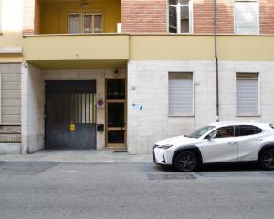 a white car parked in front of a building at WW Home: Airco, Politecnico, Atp in Turin