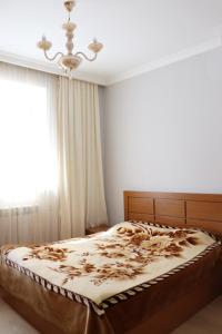 um quarto com uma cama grande e um lustre em Sergeys house em Dilijan