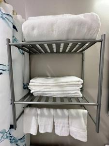 a group of towels on a shelf in a bathroom at Exec Lux home wth 3 Level,6 Bdrms/3bth & 2 Kitchen in Chicago