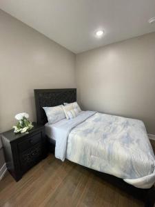 a bedroom with a large bed and a night stand at Exec Lux home wth 3 Level,6 Bdrms/3bth & 2 Kitchen in Chicago