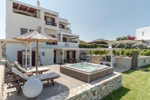 a villa with a swimming pool and a house at Aurora in Stelida
