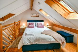 a bedroom with a large bed in the attic at Fifth Milestone Annexe in York