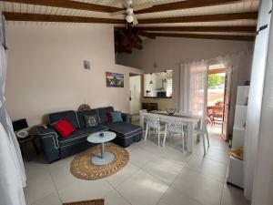 a living room with a couch and a table at Biscuit - Gîte du moulin in Petit-Canal