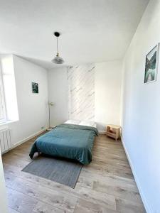 a bedroom with a bed in a white room at La Liberté I Central I Parking gratuit in Romans-sur-Isère