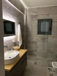 a bathroom with a sink and a mirror at Central & Beautiful in Sitia