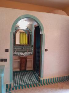 a bathroom with a mirror and a sink at Dar Marhaba Merzouga in Merzouga