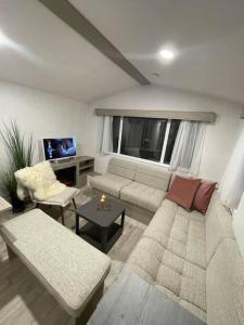 a living room with a couch and a table at Garden guest house in Høvik