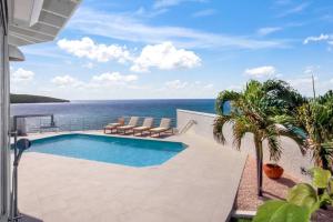 a swimming pool with a view of the ocean at Puerta Al-Mar Villa in Simpson Bay
