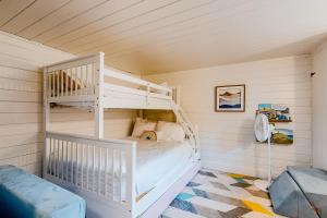 a bedroom with a white bunk bed in a room at Sea Good in Saint George