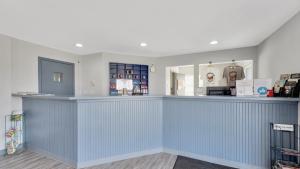 a bar in a store with a blue counter at Schmidt's Creek Hotel in Osage Beach