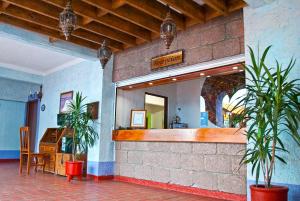 a restaurant with a counter and plants in a room at Villas Arqueologicas Teotihuacan in San Juan Teotihuacán +70 photos