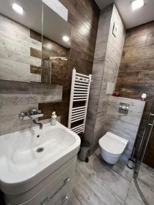 a bathroom with a sink and a toilet at Johannesburg Spacious Family apt w Free Parking and Playground in Sofia +14 photos