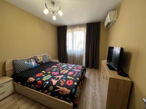 a bedroom with a bed and a flat screen tv at Johannesburg Spacious Family apt w Free Parking and Playground in Sofia