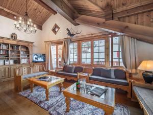 a living room with a couch and a table at Chalet Courchevel 1650, 7 pièces, 12 personnes - FR-1-563-17 in Courchevel