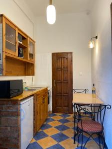 a kitchen with a table and two chairs in it at Cozy & stylish city centre flat in Budapest