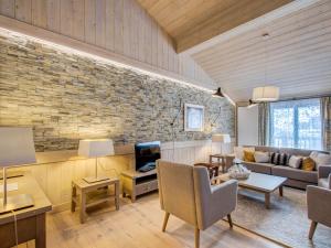 a living room with a brick wall at Appartement Courchevel 1550, 4 pièces, 6 personnes - FR-1-562-34 in Courchevel