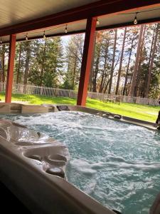 a jacuzzi tub with water in it in a yard at Mountain Cabin With Hot Tub. A Gem In The Forest! in Wofford Heights