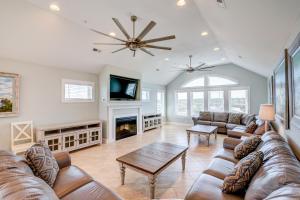 a living room with a couch and a fireplace at 5376 - Wench's Pad 2 by Resort Realty in Kill Devil Hills