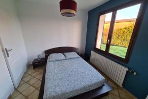 a small bedroom with a bed and a window at La Graviere - 28pers - swimming pool pétanque billiards in Fontenay-Trésigny