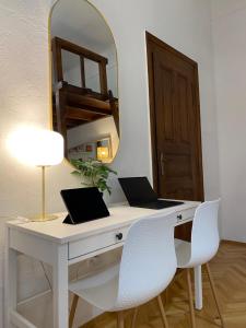 a desk with two laptops on it with a mirror at Cozy & stylish city centre flat in Budapest