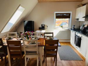 a kitchen and dining room with a table and chairs at Ferienwohnung Peters in Hünfeld