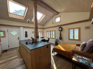 a room with a bed and a kitchen with windows at Romantic private superior Swiss Chalet with Hottub in Lungern