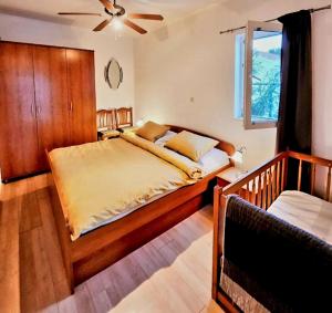 a bedroom with a large bed with a ceiling fan at Apartments Marita in Ston