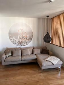 a living room with a couch and a painting on the wall at Ruhiges Designer Apartment in Zentrum & Rheinnähe in Bonn