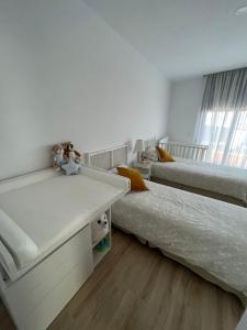 a bedroom with two beds and a desk and a window at Casa con vistas y piscina privada in Málaga +24 photos