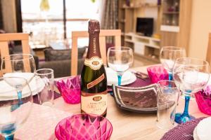 a bottle of champagne sitting on a table with glasses at Apartment Marina Alcaidesa 2 beds Golf & Beach in La Alcaidesa
