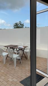 a table and chairs on a patio with a table and chairs at Mike’s House in Lourinhã