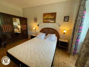 a bedroom with a large white bed with two tables at Gîte Thiré, 4 pièces, 5 personnes - FR-1-426-396 in Thiré