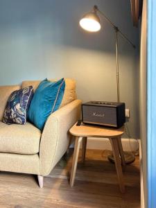 un soggiorno con divano e tavolo con computer portatile di The Fiddich Luxury Home in Craigellachie a Craigellachie