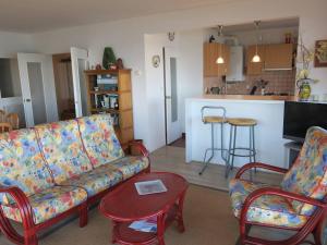 a living room with a couch and two chairs and a table at Appartement à Perros-Guirec avec Vue Panoramique, Terrasse et Parking Privé - FR-1-368-271 in Perros-Guirec