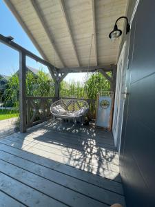 a porch with a table and a swing at Przystanek Prawdowo in Mikołajki +96 photos