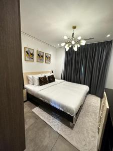 a bedroom with a large bed with a ceiling fan at Beaufort Ridge 402 in Accra
