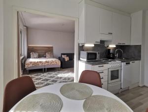 una cucina e un soggiorno con tavolo e sedie di Rovaniemi Cityhome Pekankatu a Rovaniemi