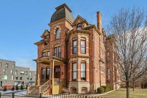 an old red brick building with a tower at The Lumber Baron's Penthouse 3BR / 2.5 BA in Detroit